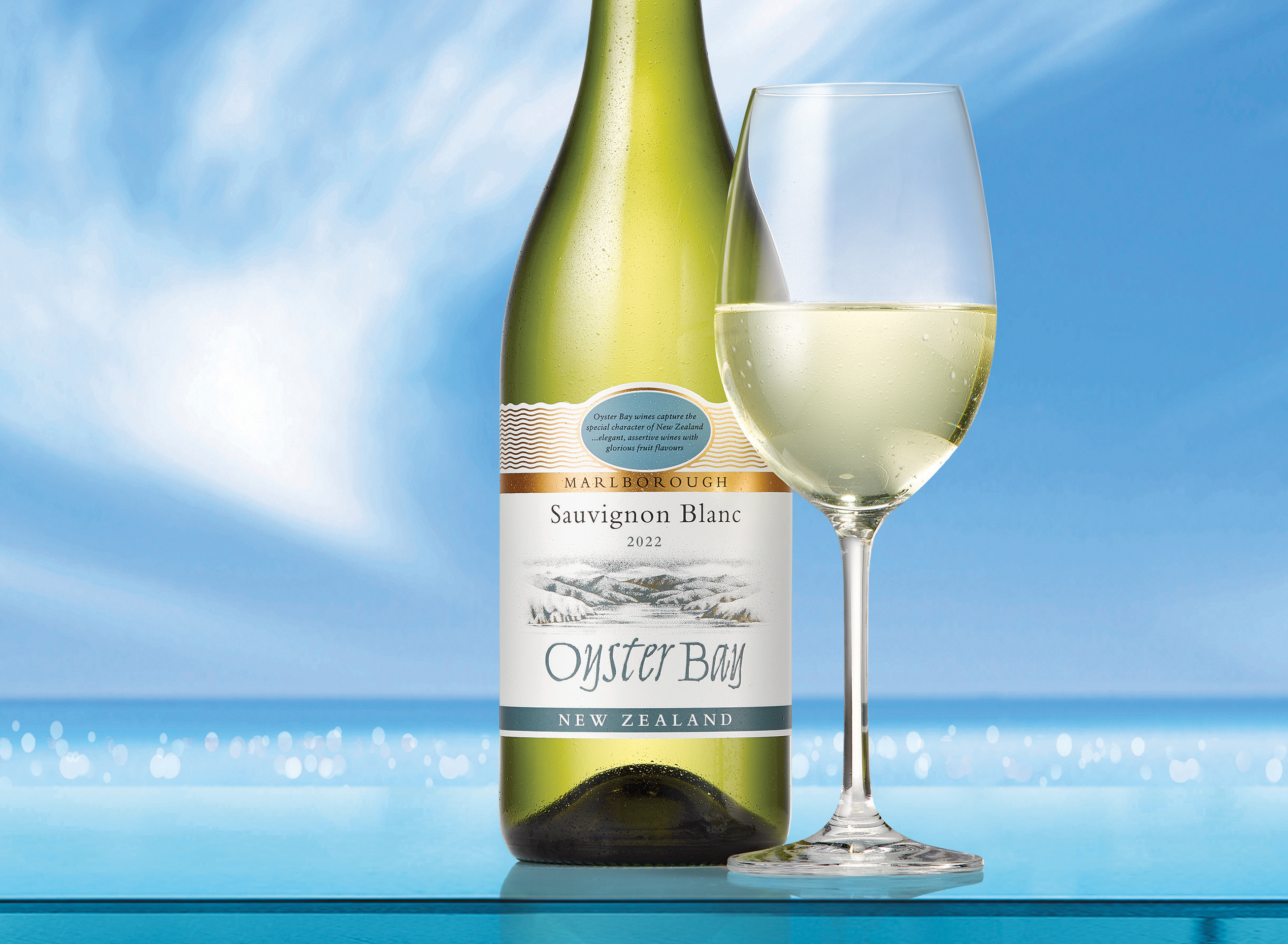Oyster Bay Marlborough New Zealand Sauvignon Blanc Wine bottle next to full glass